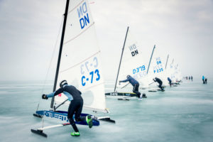 Ice sailing European Championship on Lake Balaton in Hungary, The participants of the regatta push their boats after the starting signal to jump up and then go sailing. The start is in the middle of the ice about 5 km from the country. Ice sailing European Championship on Lake Balaton in Hungary, The participants of the regatta push their boats after the starting signal to jump up and then go sailing. The start is in the middle of the ice about 5 km from the country.